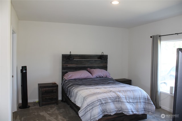 bedroom with dark colored carpet