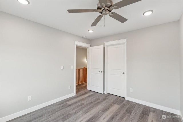 unfurnished bedroom featuring ceiling fan and light hardwood / wood-style floors