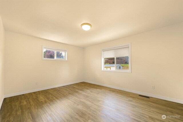 spare room featuring hardwood / wood-style floors