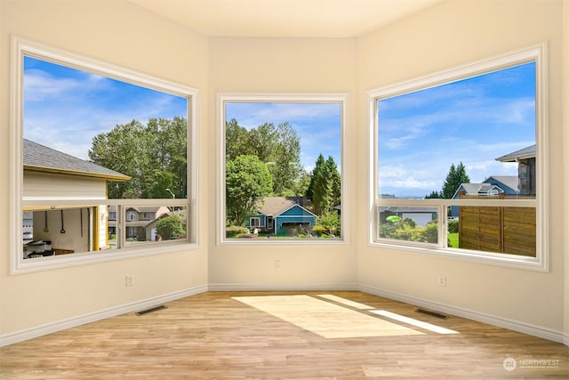 unfurnished sunroom with visible vents