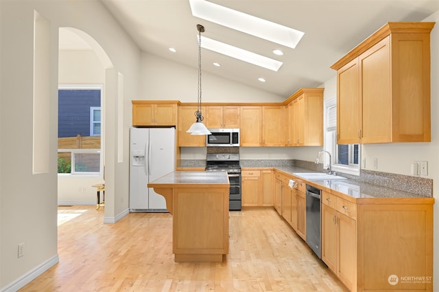 kitchen with a skylight, a center island, light hardwood / wood-style flooring, stainless steel appliances, and sink