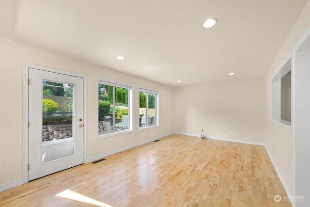 spare room with light hardwood / wood-style flooring