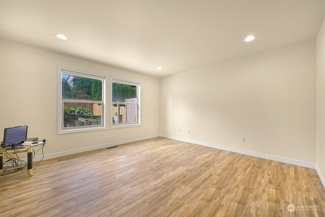 spare room with light hardwood / wood-style flooring