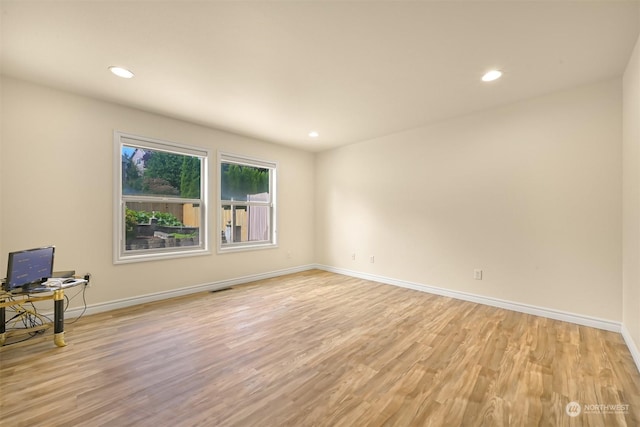 unfurnished room with baseboards, recessed lighting, visible vents, and light wood-style floors