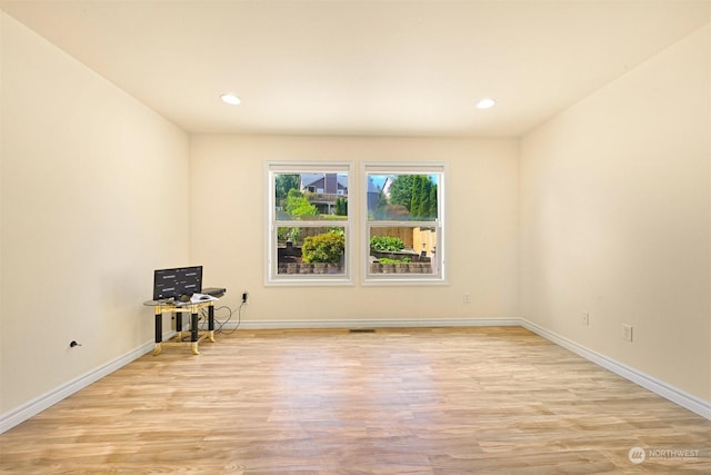 unfurnished room with recessed lighting, visible vents, light wood-style flooring, and baseboards