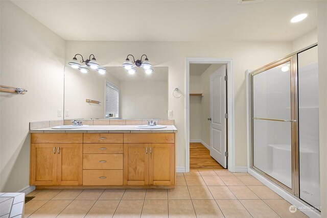 bathroom featuring vanity, hardwood / wood-style flooring, and an enclosed shower