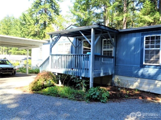 view of front facade featuring a deck and a carport