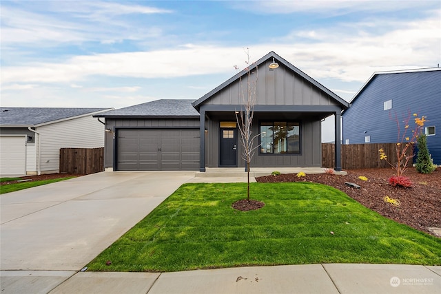 view of front of property featuring a front lawn, a garage, and a porch