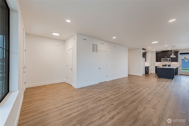 unfurnished living room with light wood-type flooring