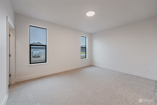 empty room featuring light carpet