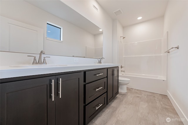 full bathroom with vanity, hardwood / wood-style flooring, toilet, and shower / bathtub combination