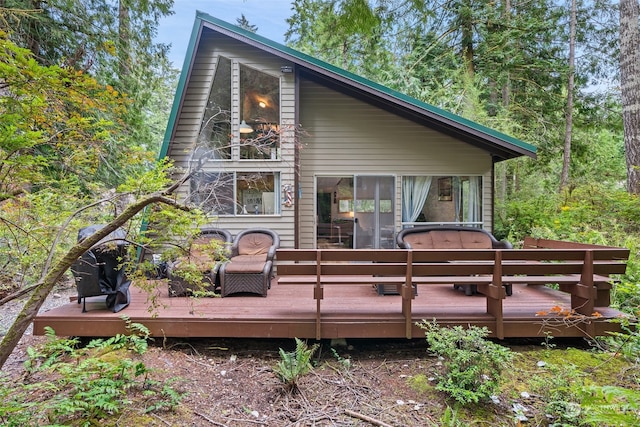 rear view of house with a wooden deck