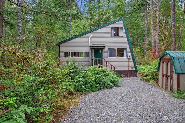 view of front of house with a shed and an outdoor structure