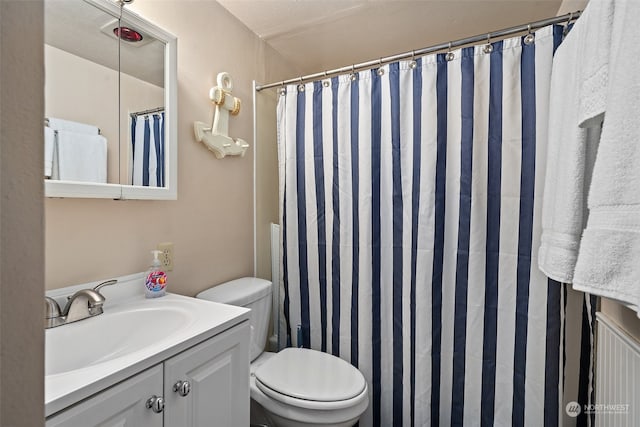 bathroom featuring toilet and vanity