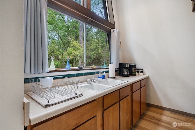 kitchen with light countertops, plenty of natural light, and brown cabinets