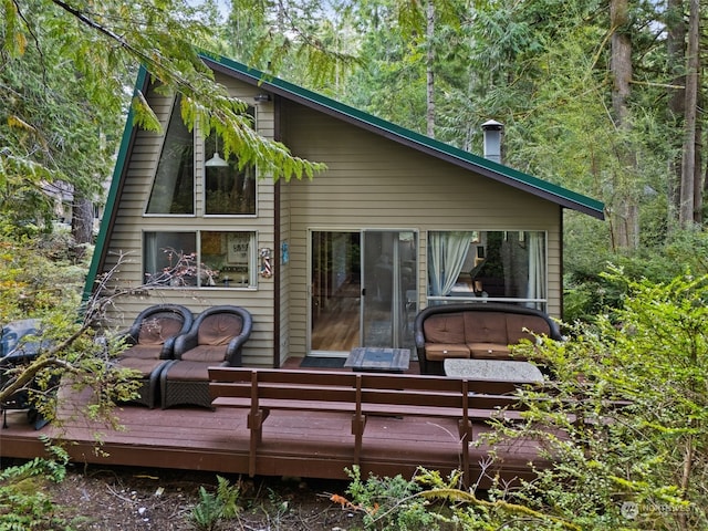 back of property featuring a deck