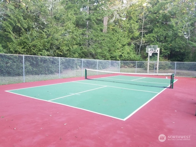 view of tennis court with fence