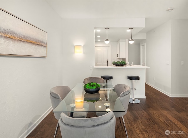 dining area with dark hardwood / wood-style flooring