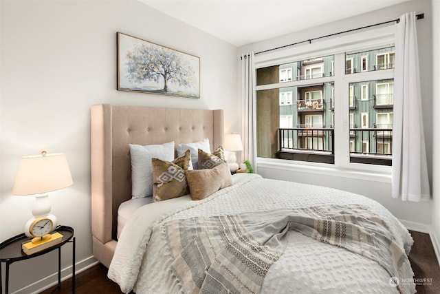 bedroom with dark hardwood / wood-style floors