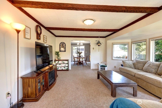 living room featuring carpet floors, crown molding, beamed ceiling, and an inviting chandelier