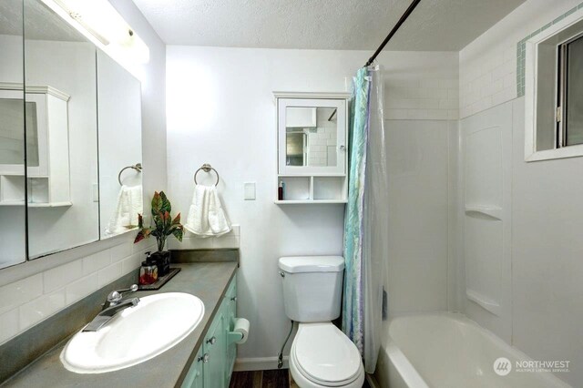 full bathroom with toilet, vanity, a textured ceiling, shower / bathtub combination with curtain, and decorative backsplash