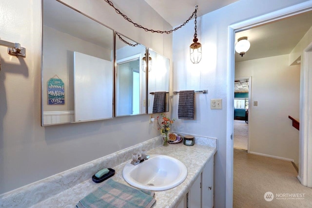 bathroom with vanity and baseboards