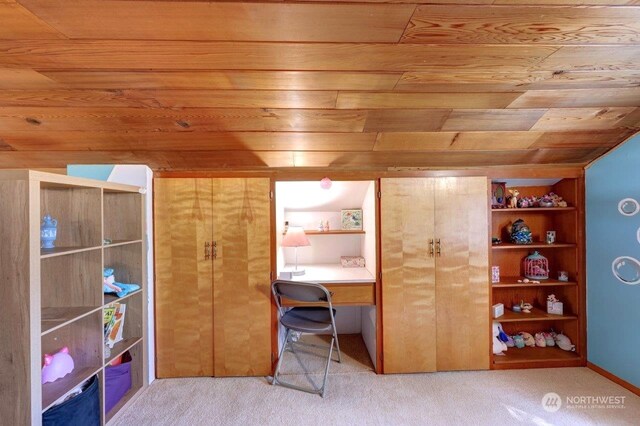 office area with wood ceiling, built in features, and carpet flooring