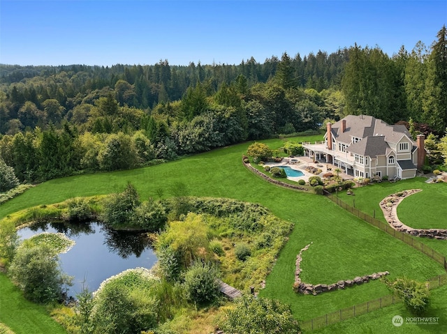 bird's eye view with a water view and a forest view