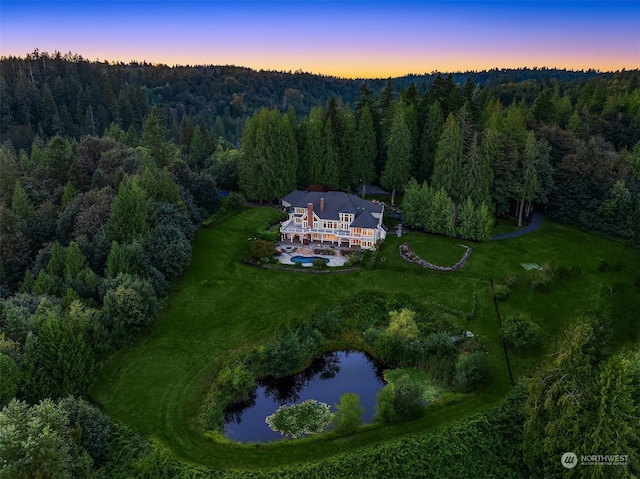 aerial view at dusk with a water view