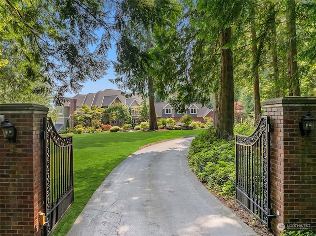 view of gate featuring a residential view and a yard