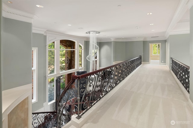 hall featuring recessed lighting, ornamental molding, baseboards, and light colored carpet