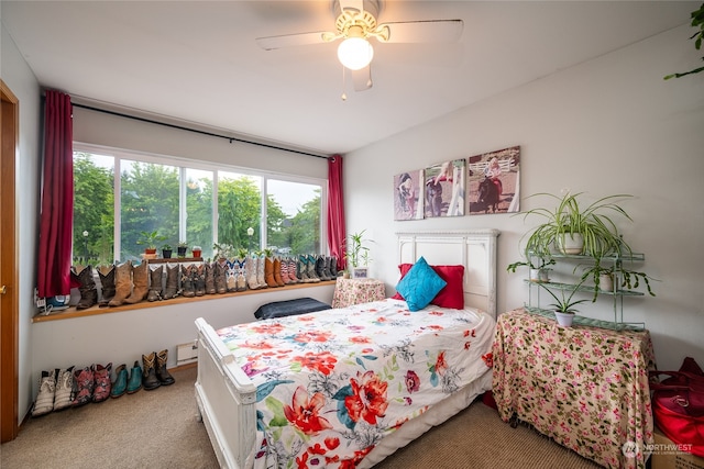 bedroom with ceiling fan and carpet floors