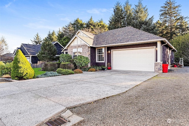 1001 Lakeview Dr, Ilwaco, WA 98624 - view of front of property with stone siding, concrete driveway, a garage, and roof with shingles