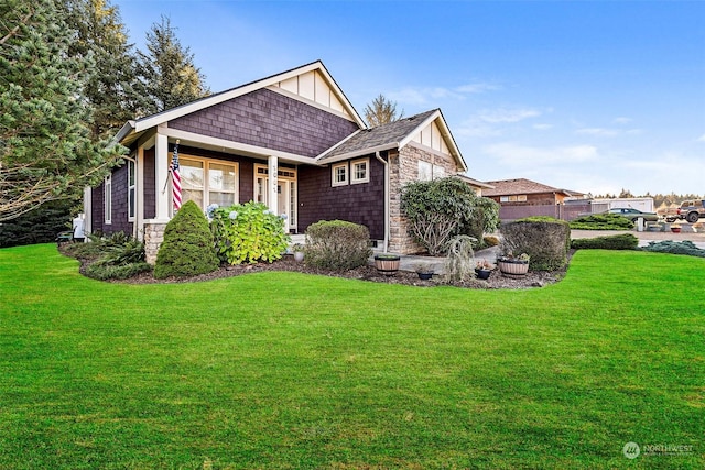 1001 Lakeview Dr, Ilwaco, WA 98624 - view of front of property with a front lawn, stone siding, board and batten siding, and roof with shingles