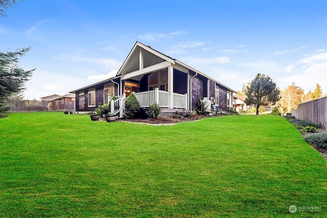 exterior space with a porch and a front yard