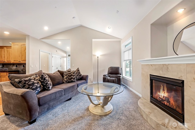 living room with a fireplace, carpet floors, and lofted ceiling