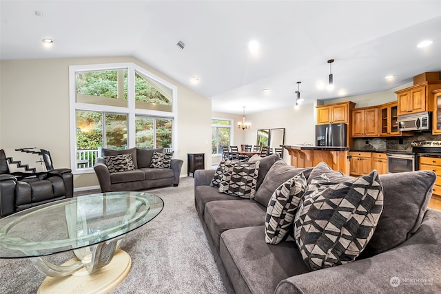 living room featuring light carpet, lofted ceiling, and an inviting chandelier