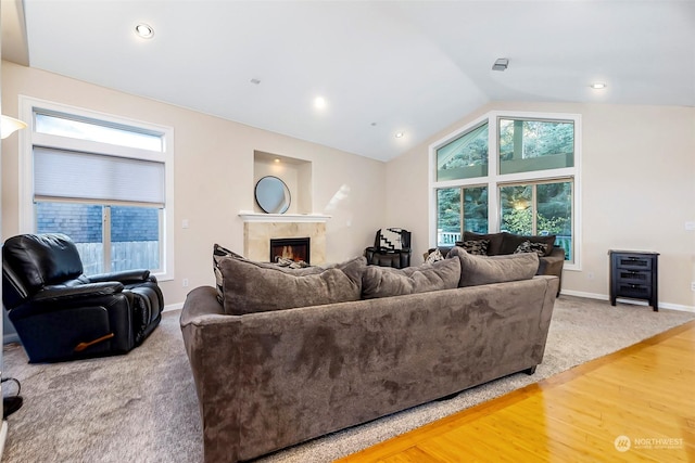 1001 Lakeview Dr, Ilwaco, WA 98624 - carpeted living room featuring a lit fireplace, vaulted ceiling, wood finished floors, and recessed lighting