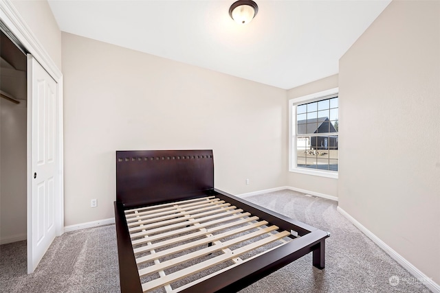 carpeted bedroom with a closet