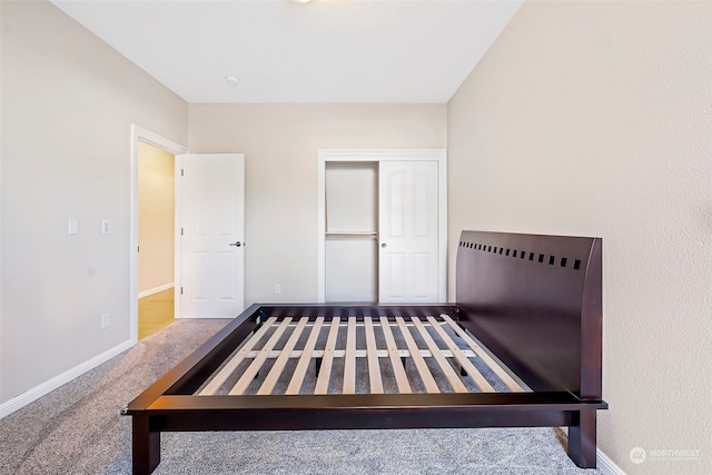 unfurnished bedroom featuring carpet flooring and a closet