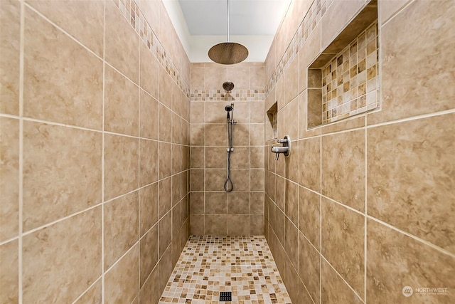 bathroom with tiled shower