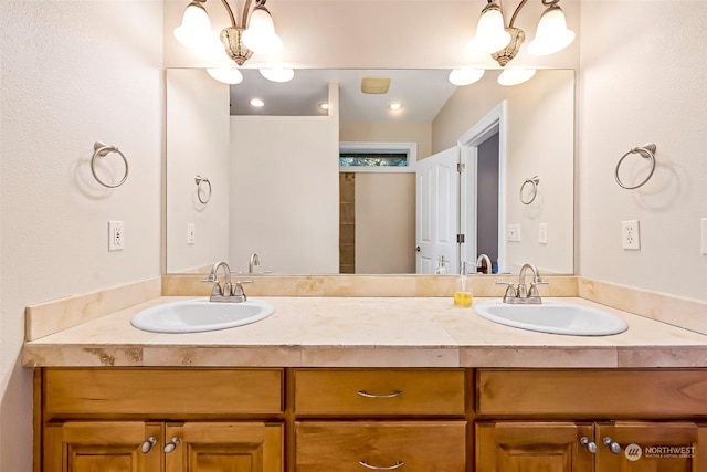 1001 Lakeview Dr, Ilwaco, WA 98624 - bathroom featuring double vanity and a chandelier