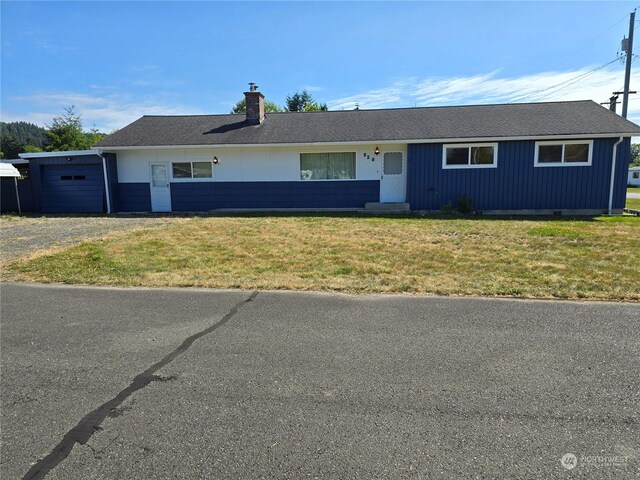 ranch-style home with a front lawn and a garage