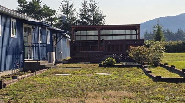 view of yard featuring a deck with mountain view