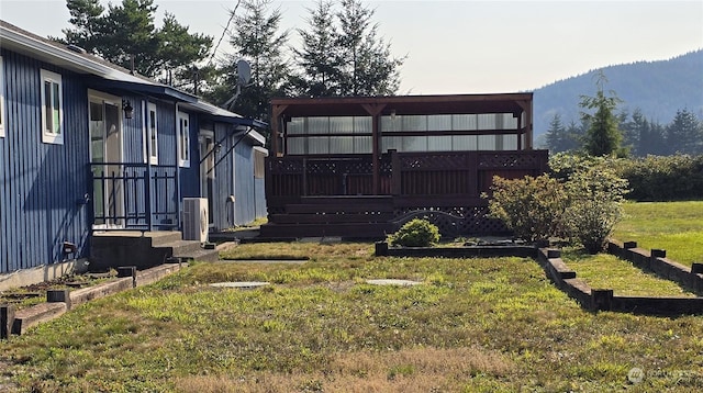 view of yard with cooling unit and a wooden deck