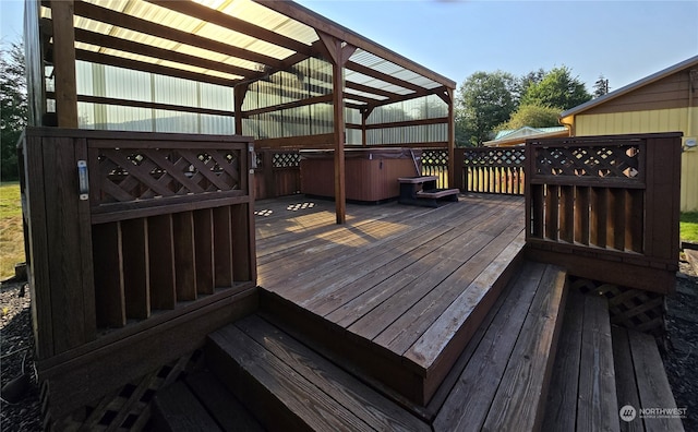 wooden deck with a hot tub