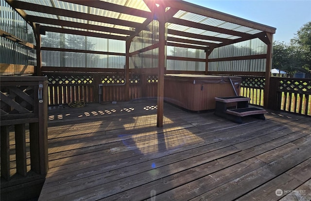 wooden deck featuring a hot tub and a pergola