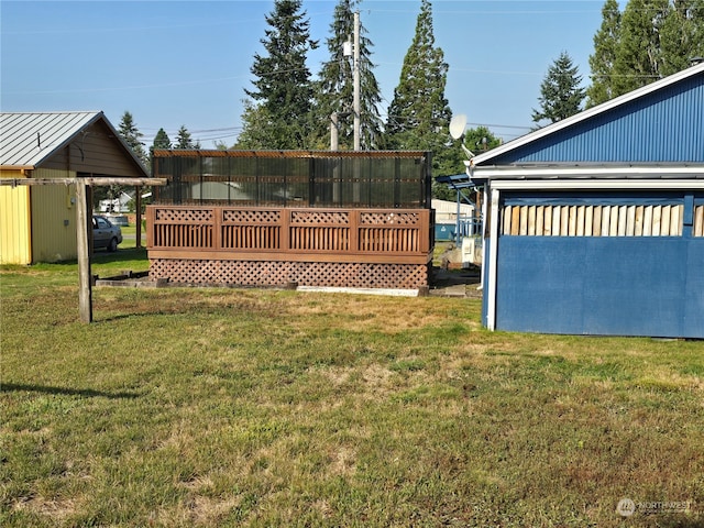 view of yard with a storage shed and a deck