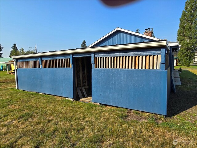 exterior space with a lawn and an outbuilding