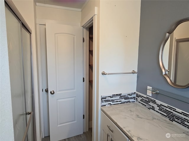 bathroom with vanity and tasteful backsplash